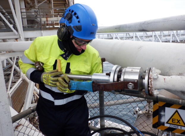 Operator Service Engineer instals an ultrasonic flowmeter transducer on an offshore platform